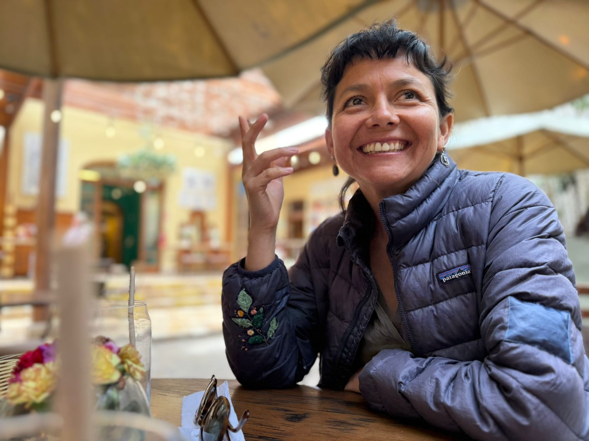 Sofia, your host, laughing across a café table