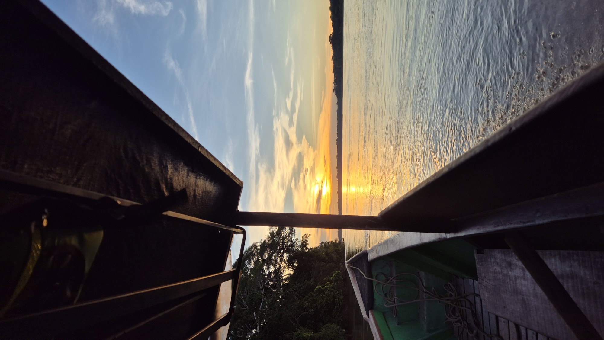 Sunset over the Tambopata river from the bow of the lodge boat