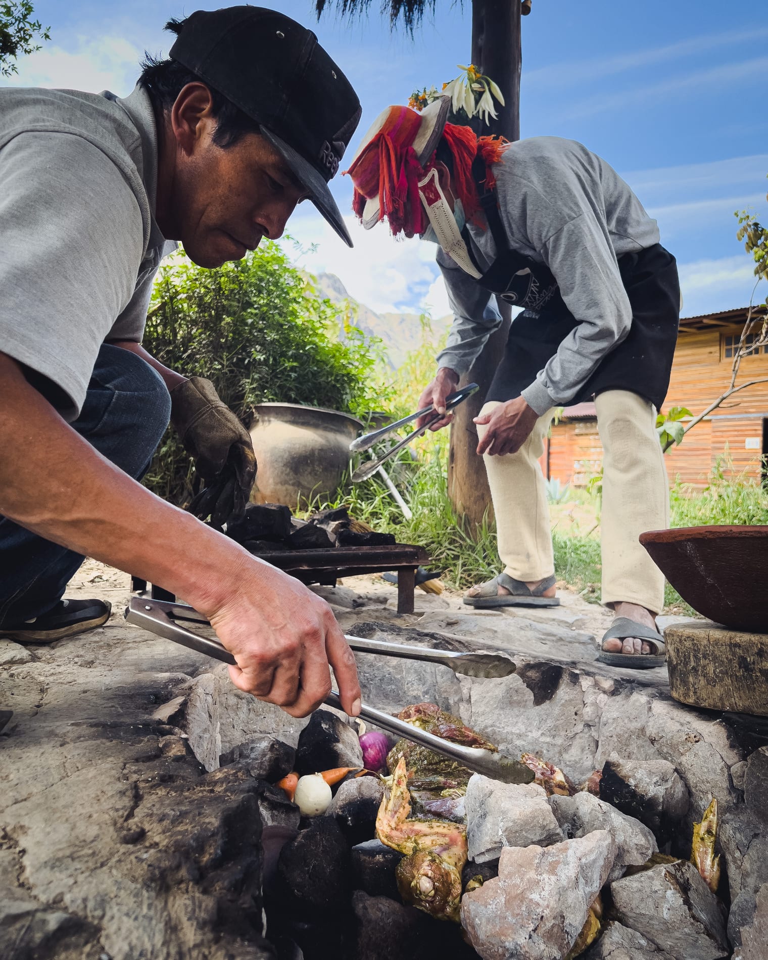 Tending the pachamanca stones in the Sacred Valley